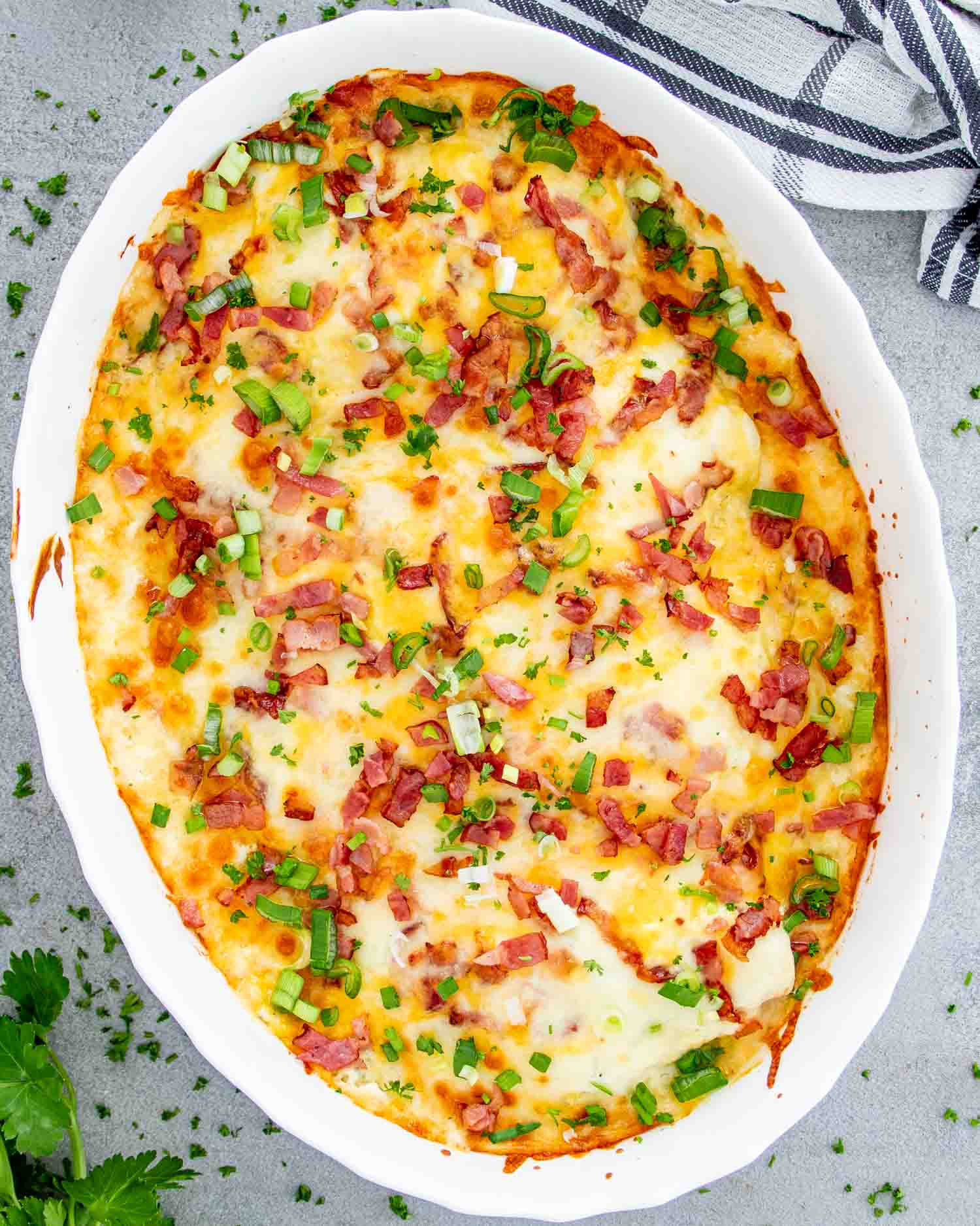fresh out of the oven baked crack chicken casserole in a white casserole dish.