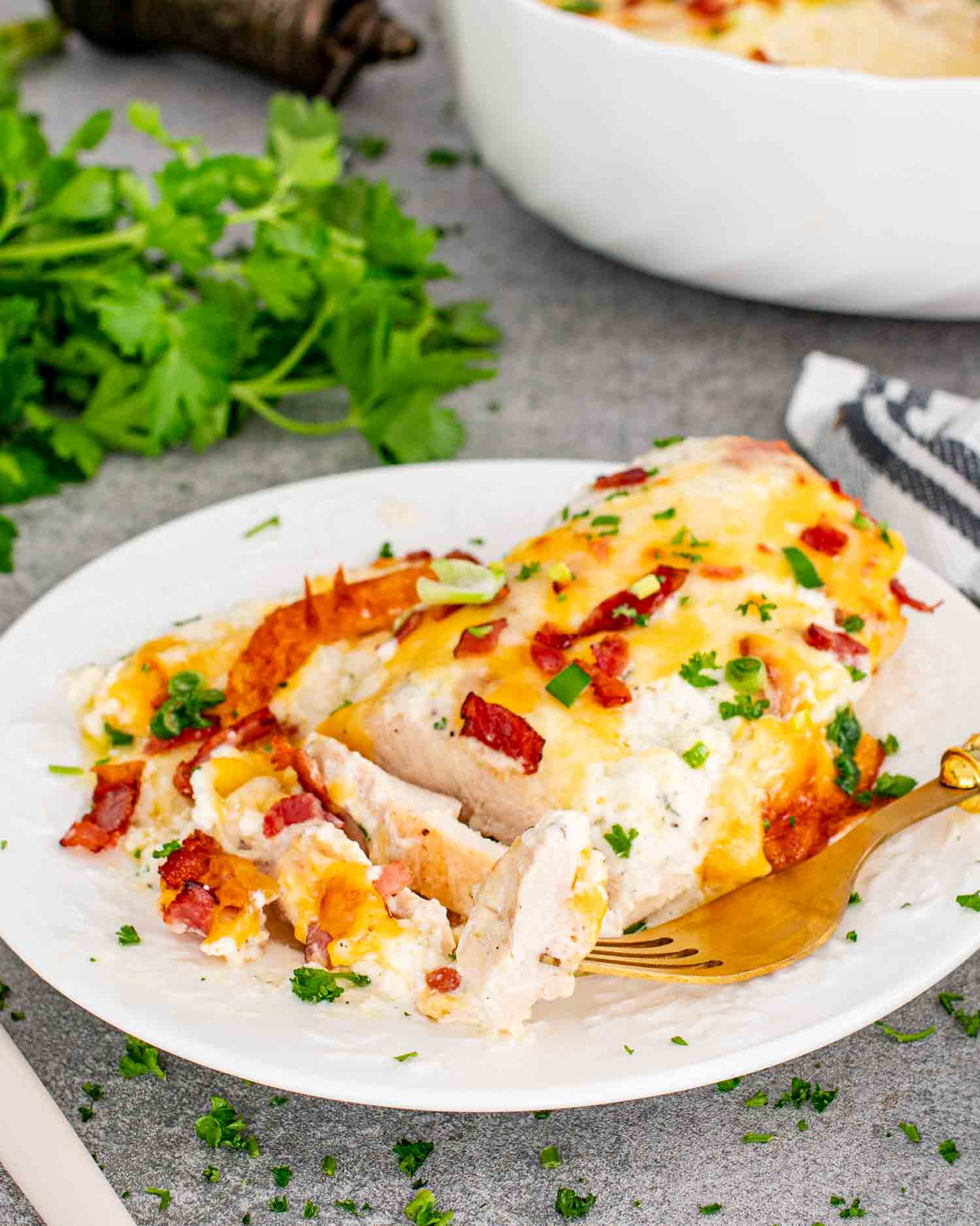 a serving of baked crack chicken sliced on a white plate.