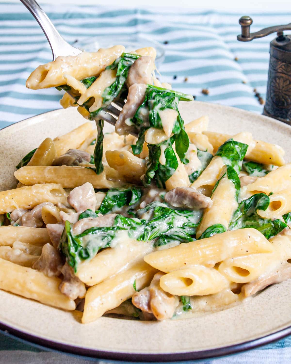 Cheesy Chicken Pasta on a beige plate