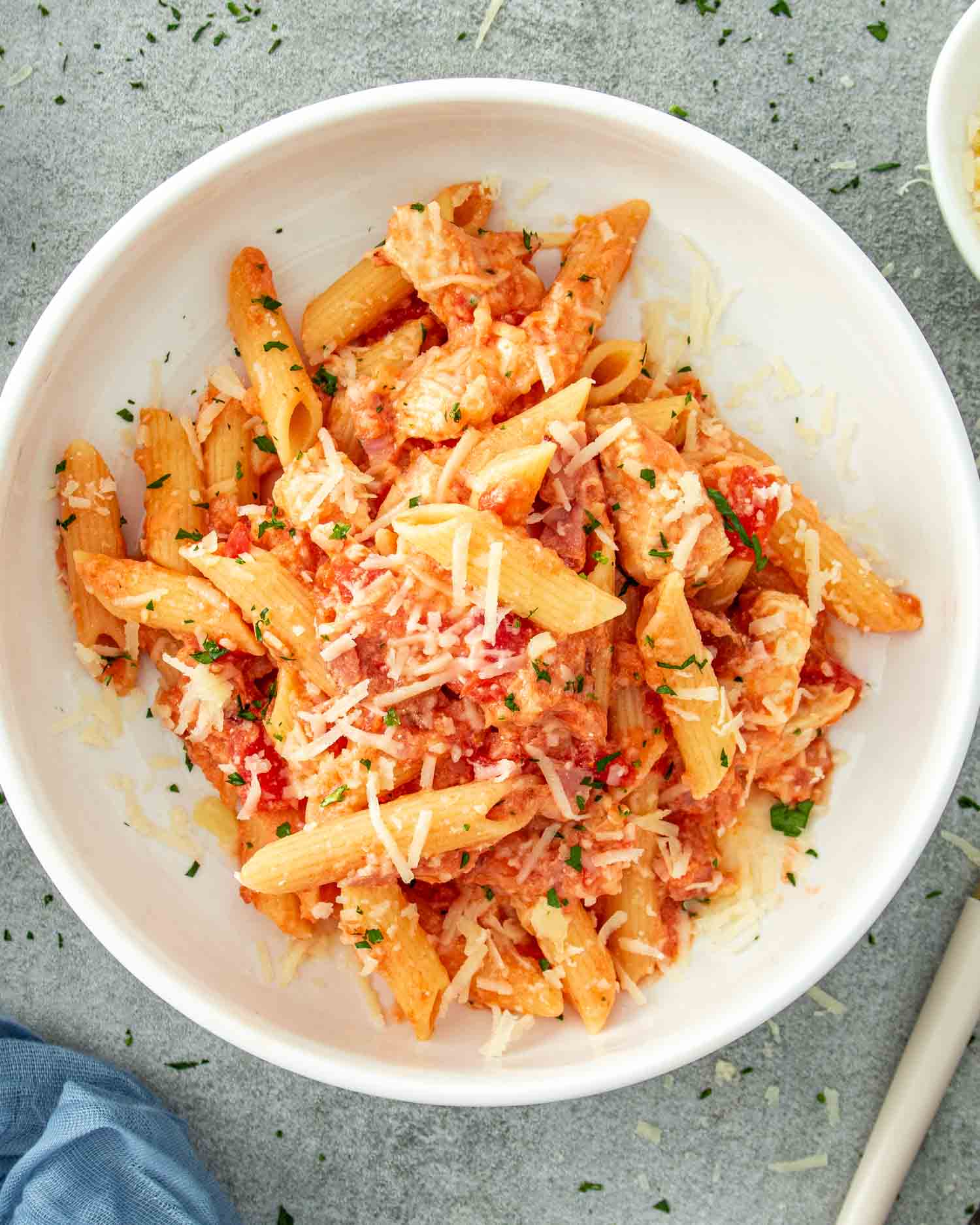 a serving of chicken bacon pasta in a white bowl.