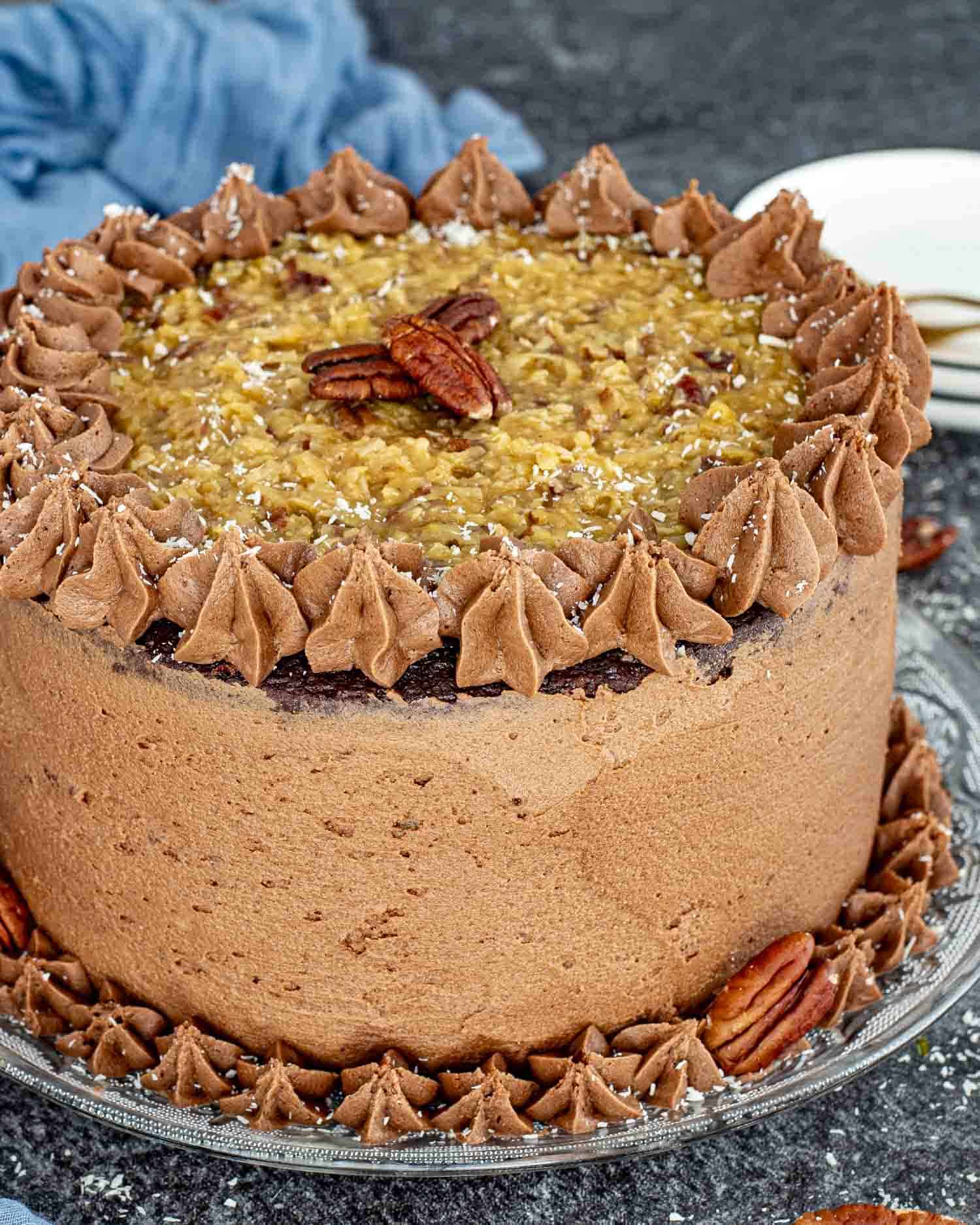 a german chocolate cake on a cake platter.