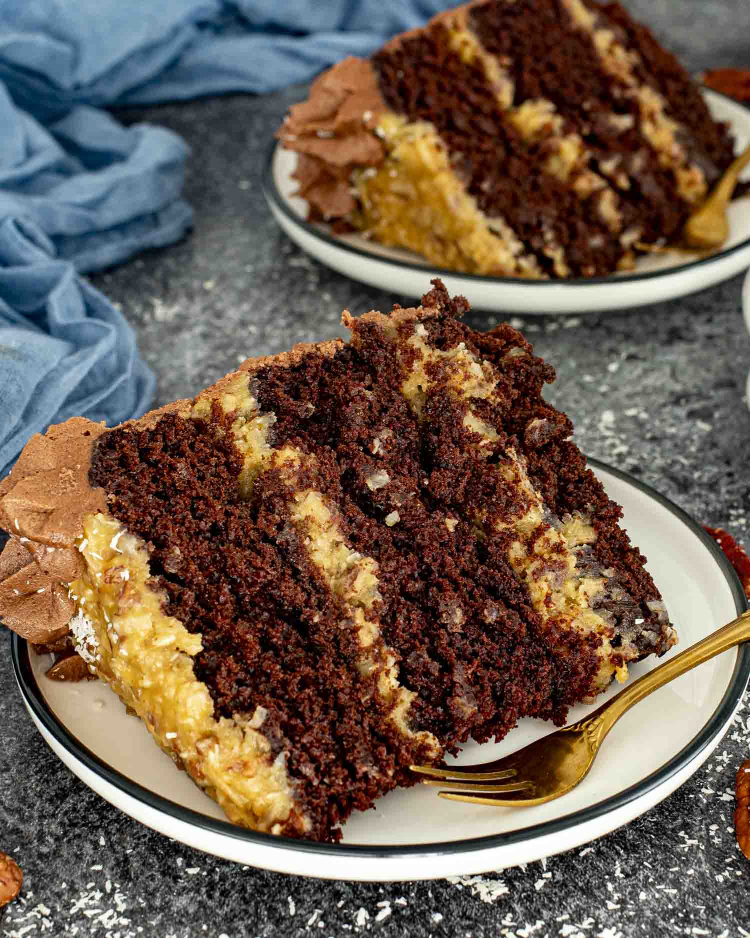 a slice of german chocolate cake on a white plate.