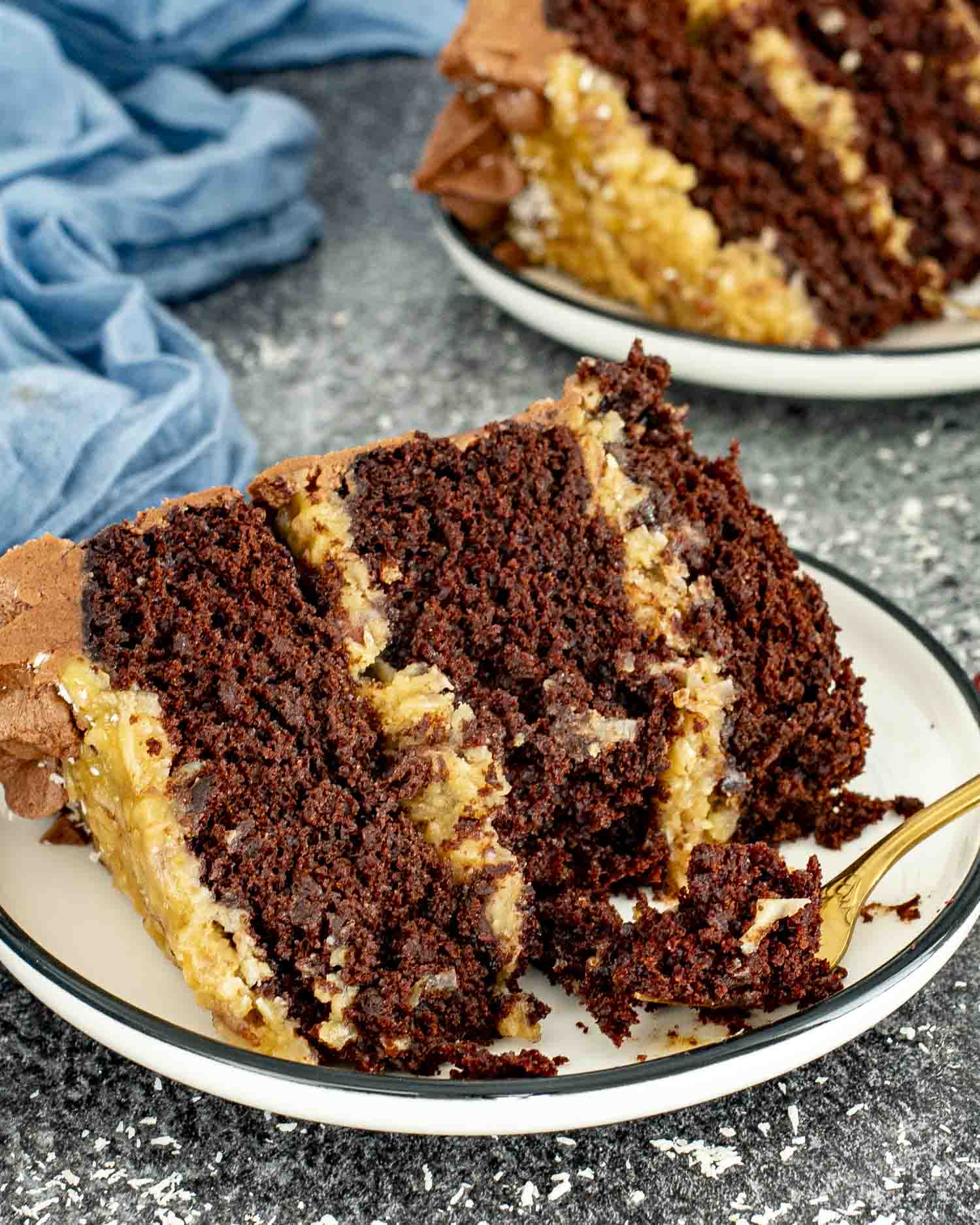 a slice of german chocolate cake on a white plate.