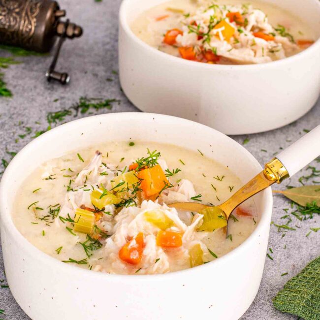 a serving of greek lemon chicken soup in a white bowl.