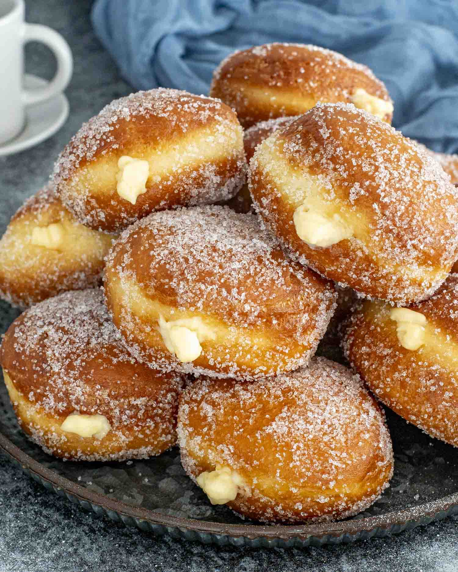 freshly made italian bomboloni on a serving platter.