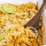 cheesy Mexican Street Corn Pasta Bake in a white casserole dish, garnished with fresh lime slices.