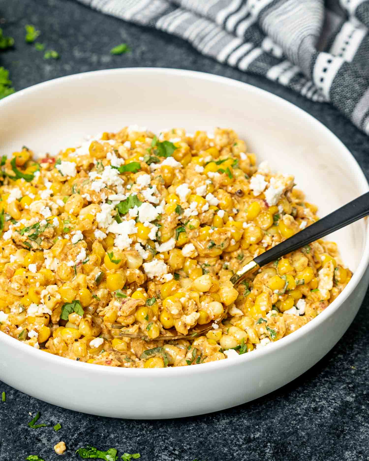 freshly made (mexican street corn salad in a white bowl.