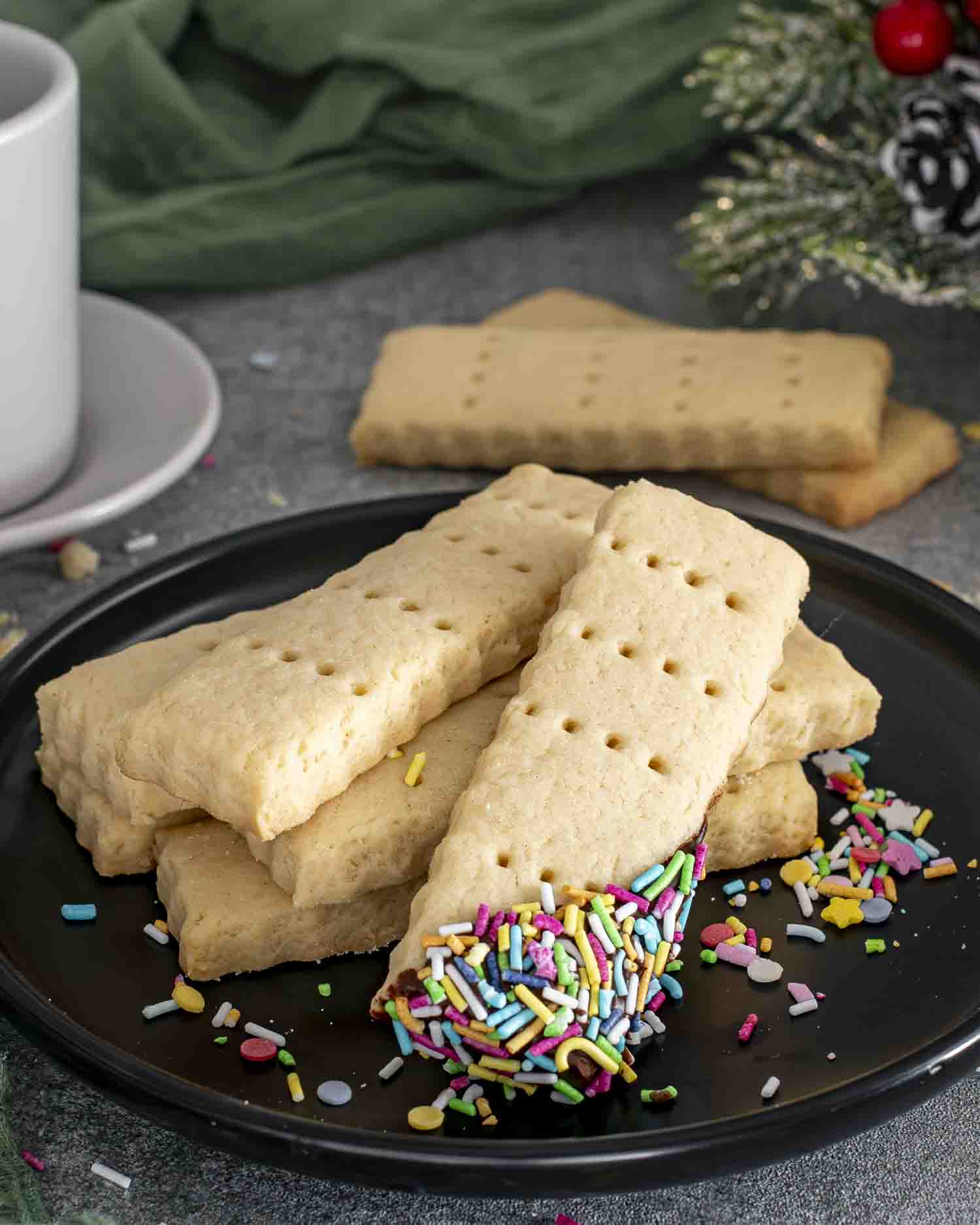 freshly baked shortbread cookies on a black plate.
