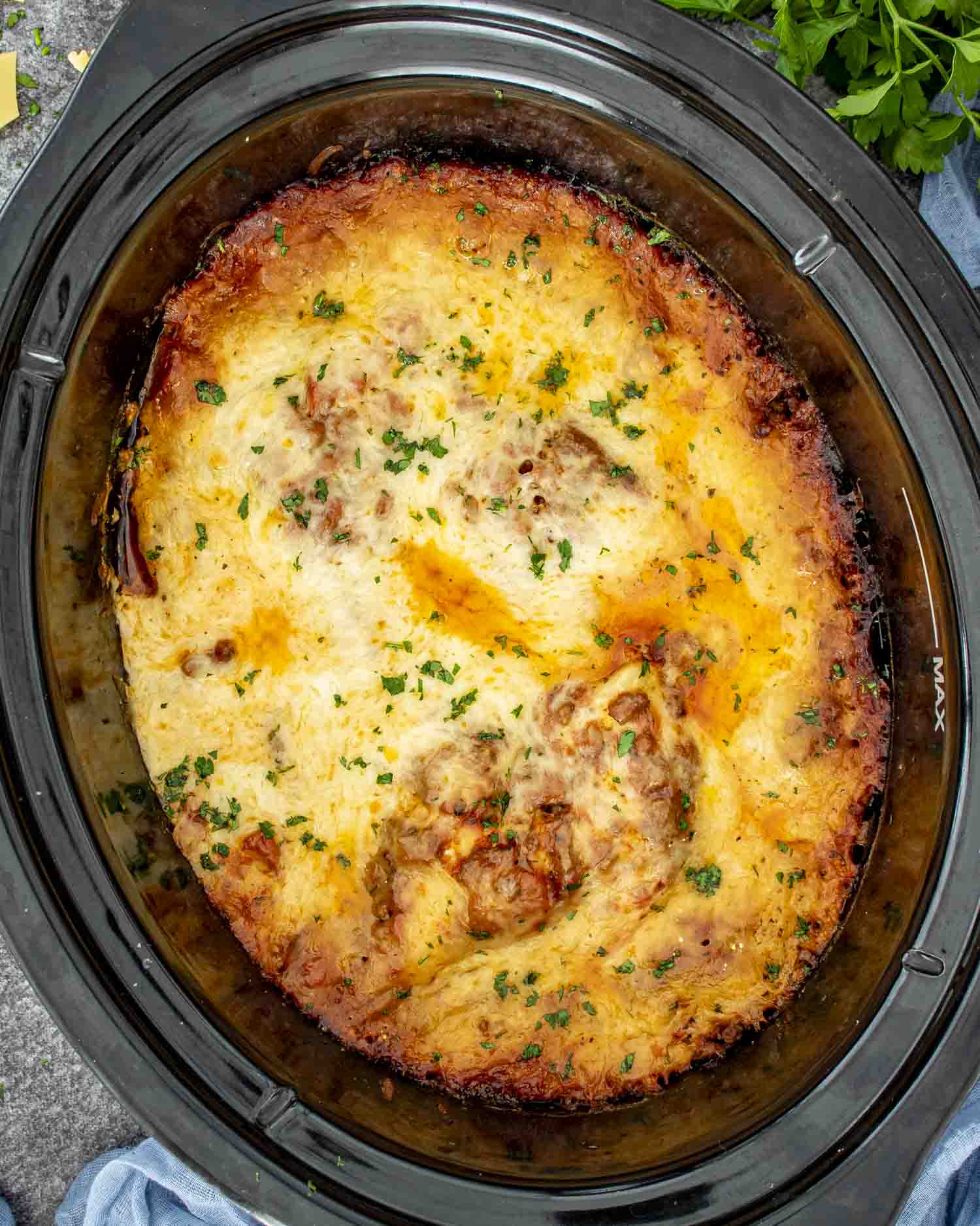 freshly made slow cooker lasagna garnished with a bit of parsley.