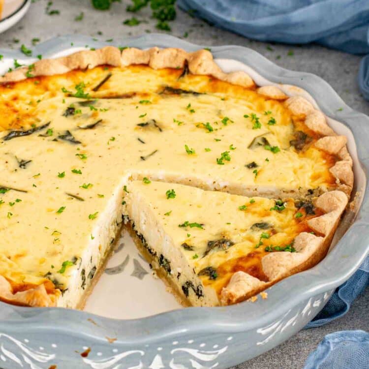 a spinach and feta quiche in a pie plate.