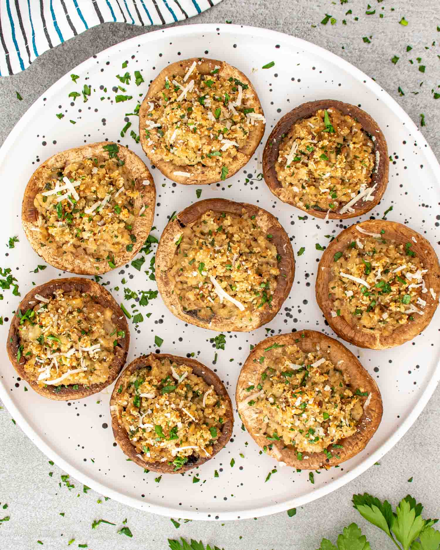 freshly made stuffed mushrooms on a white plate.