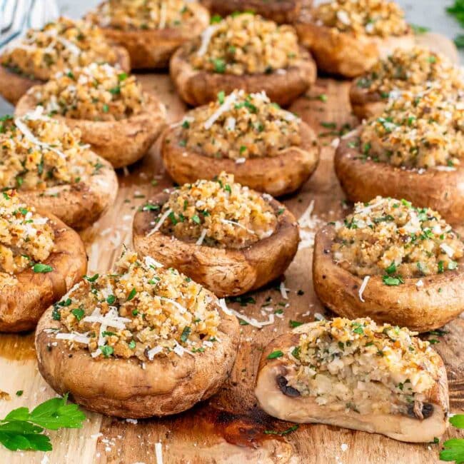 stuffed mushrooms on a cutting board.