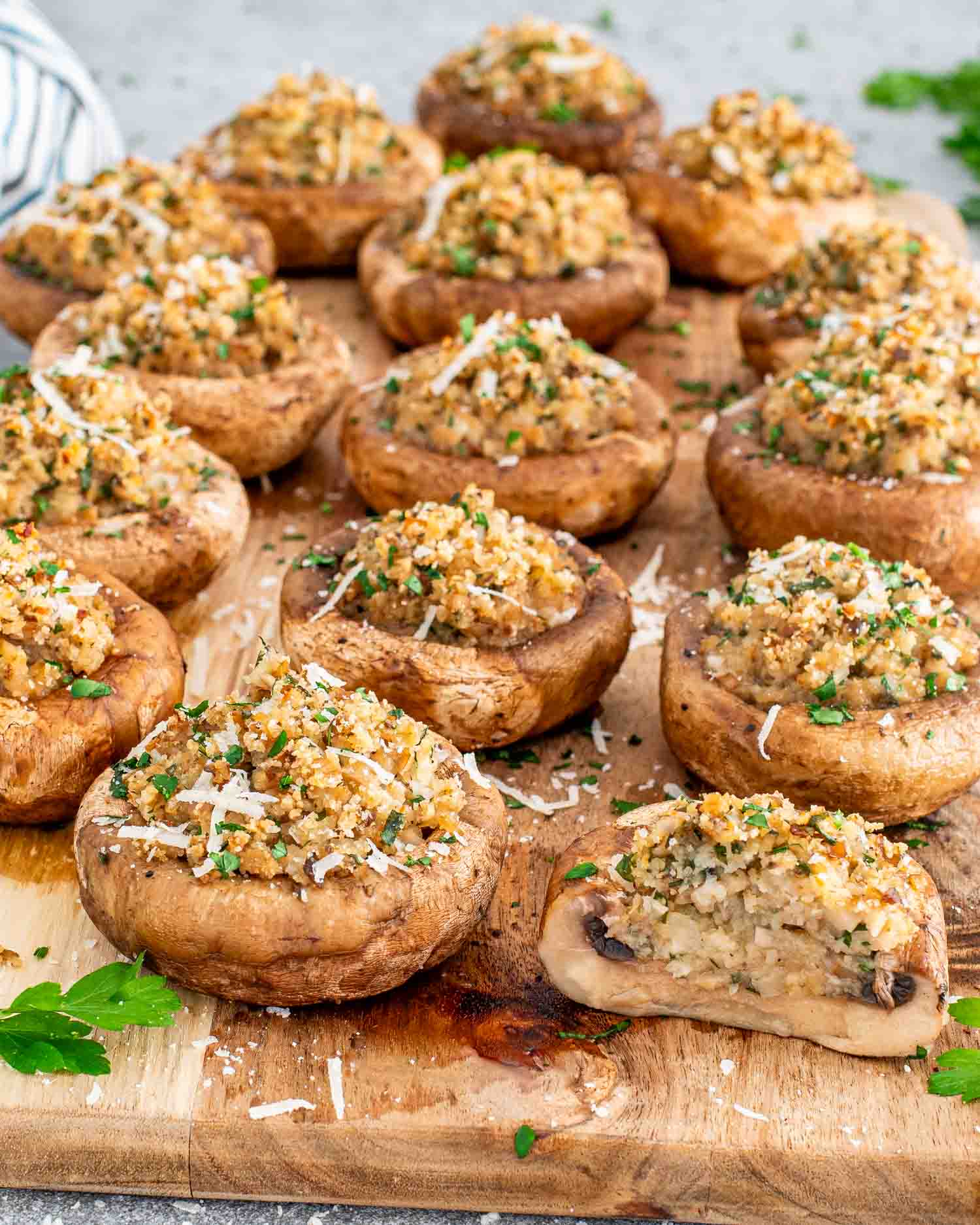 stuffed mushrooms on a cutting board.