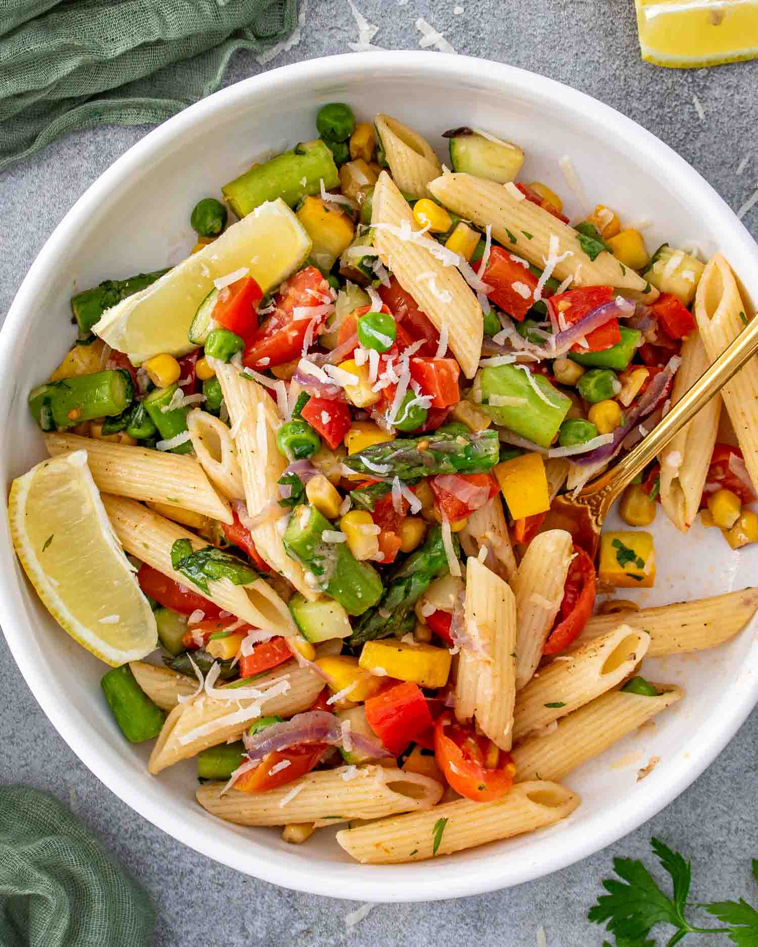 a serving of freshly made pasta primavera in a pretty white bowl.
