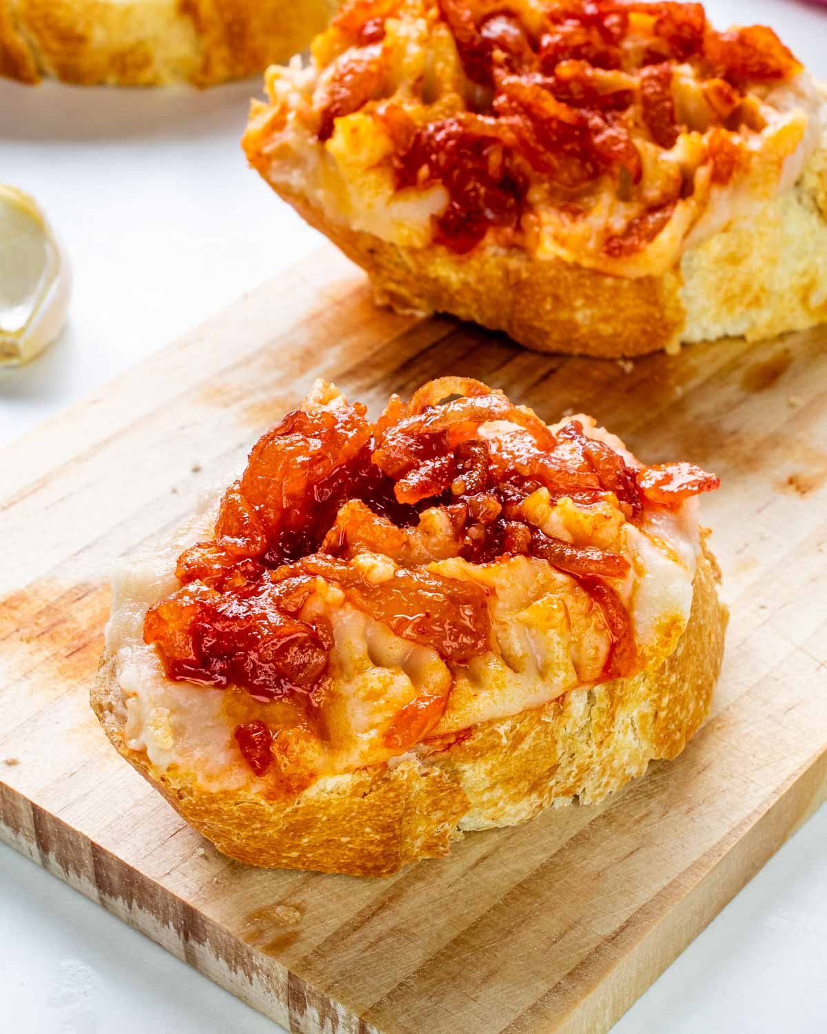 white bean dip spread on slices of french baguette.