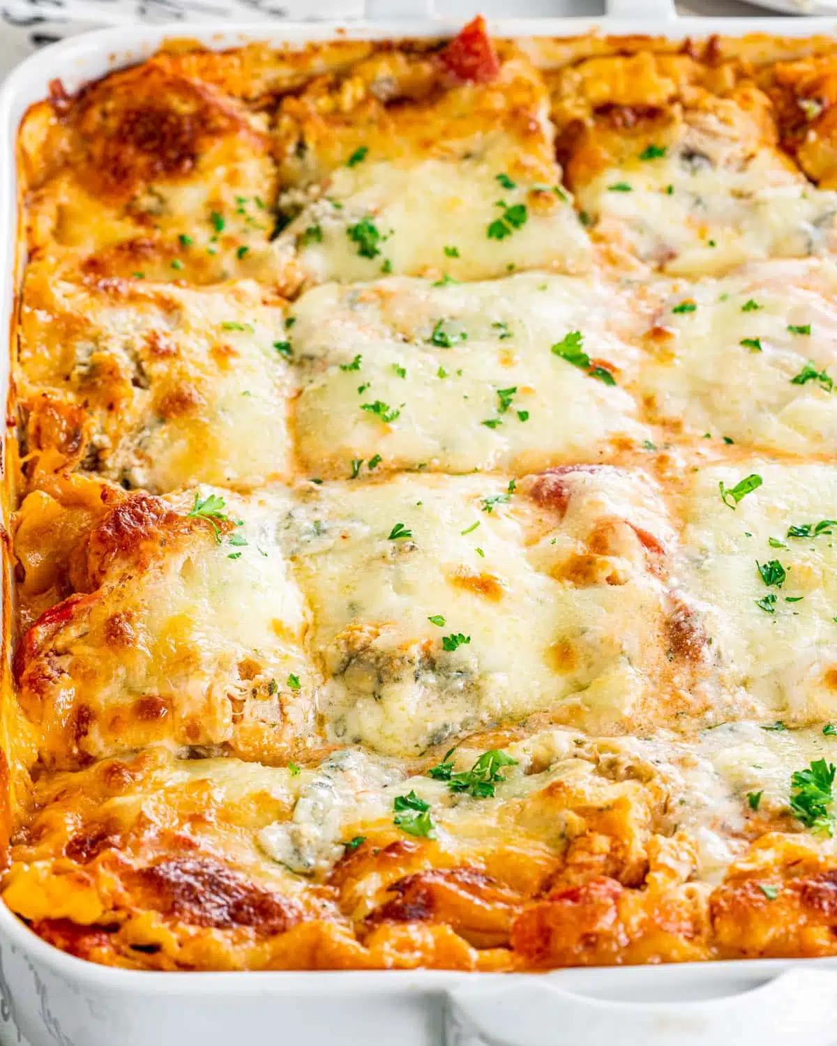 lasagna in a white casserole dish