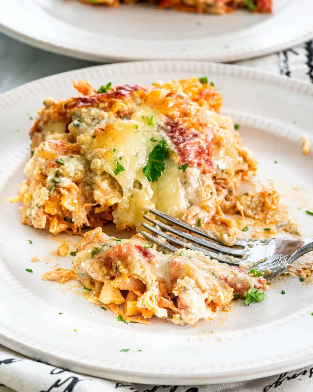 a slice of Buffalo Chicken Lasagna on a white plate