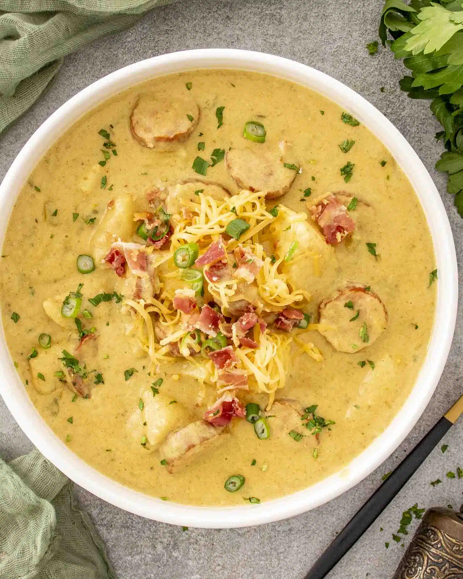 a white bowl loaded with cajun potato soup.