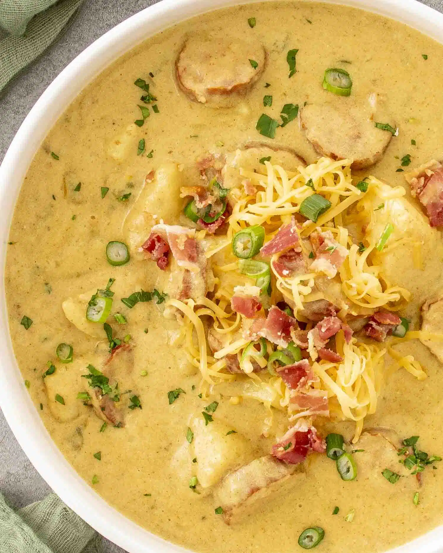 a white bowl loaded with cajun potato soup.