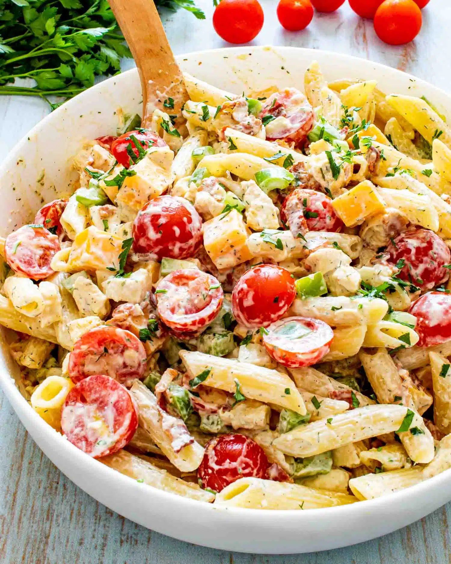 chicken club pasta salad in a white bowl.