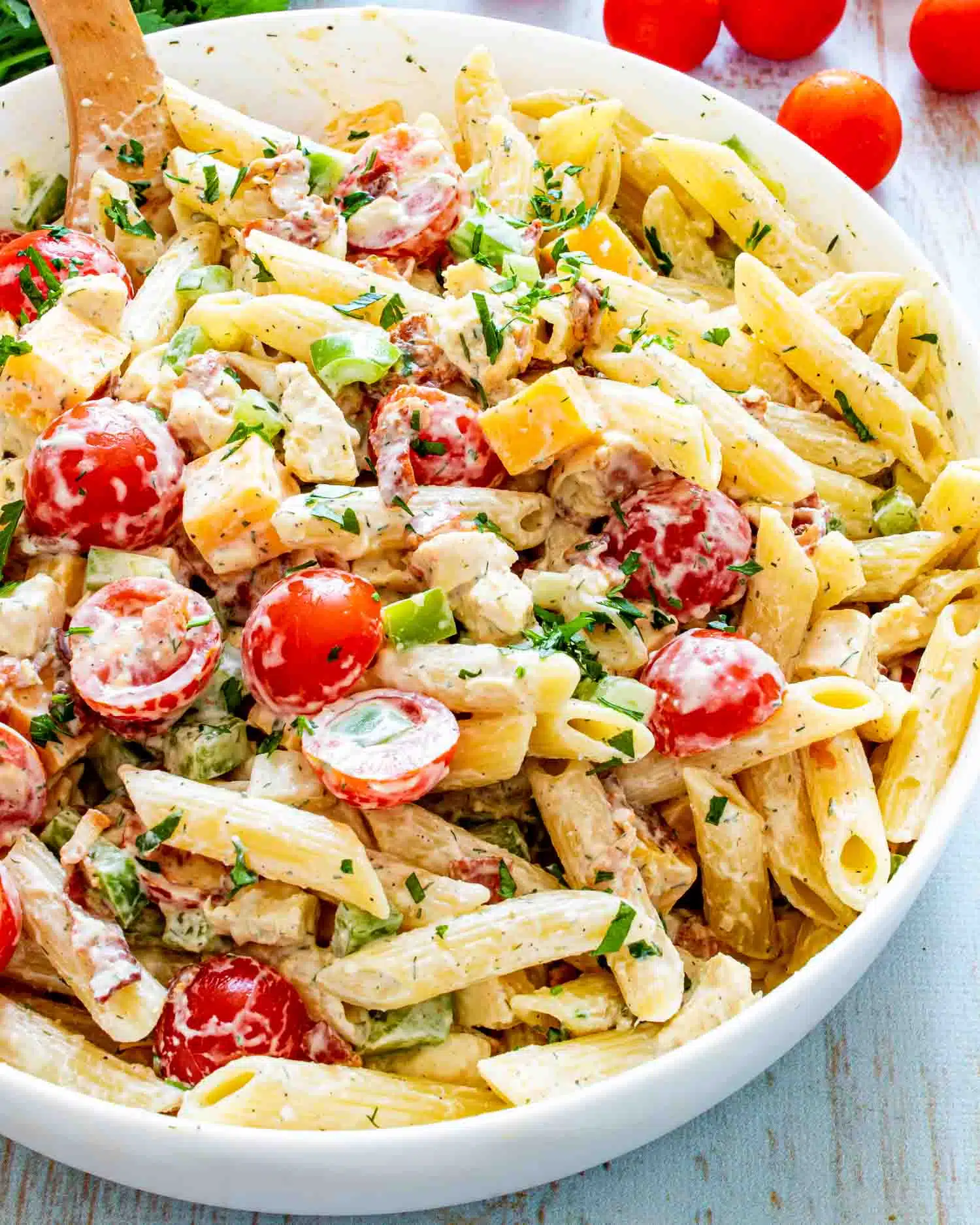 chicken club pasta salad in a white bowl.