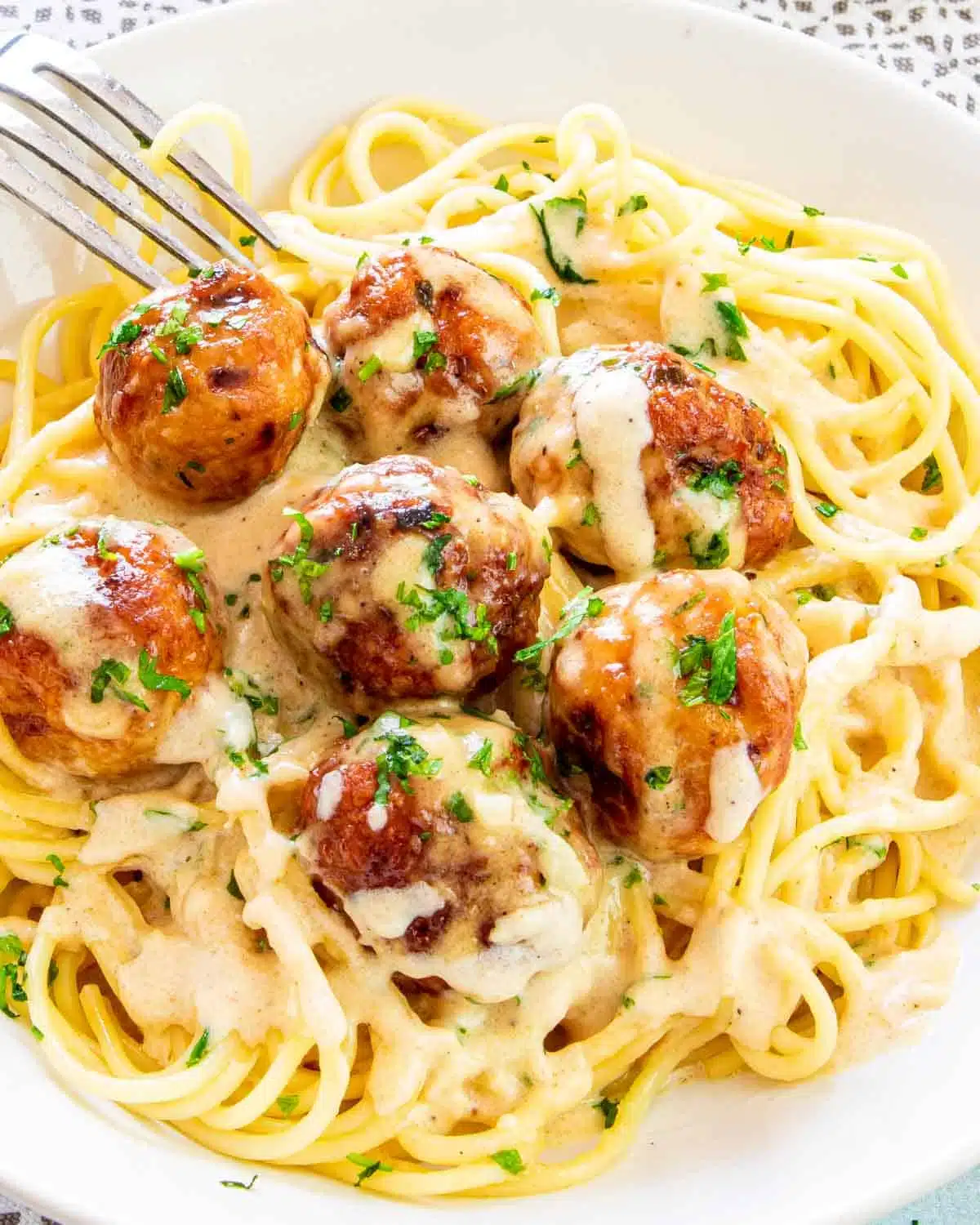 chicken meatballs with alfredo sauce and spaghetti.
