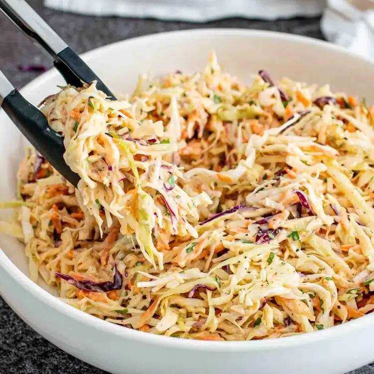 freshly made coleslaw in a white bowl.