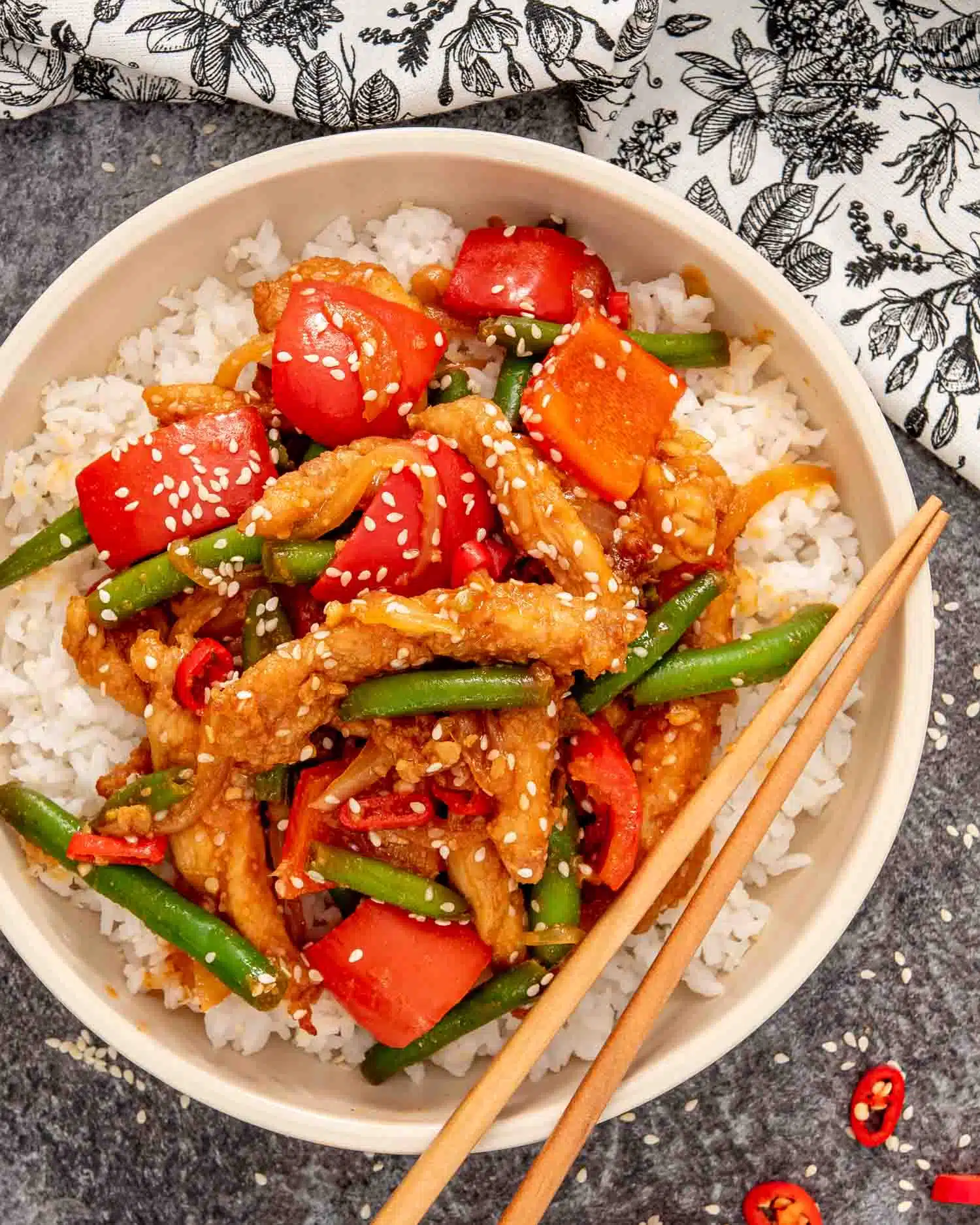crispy honey chili chicken with rice in a beige bowl.