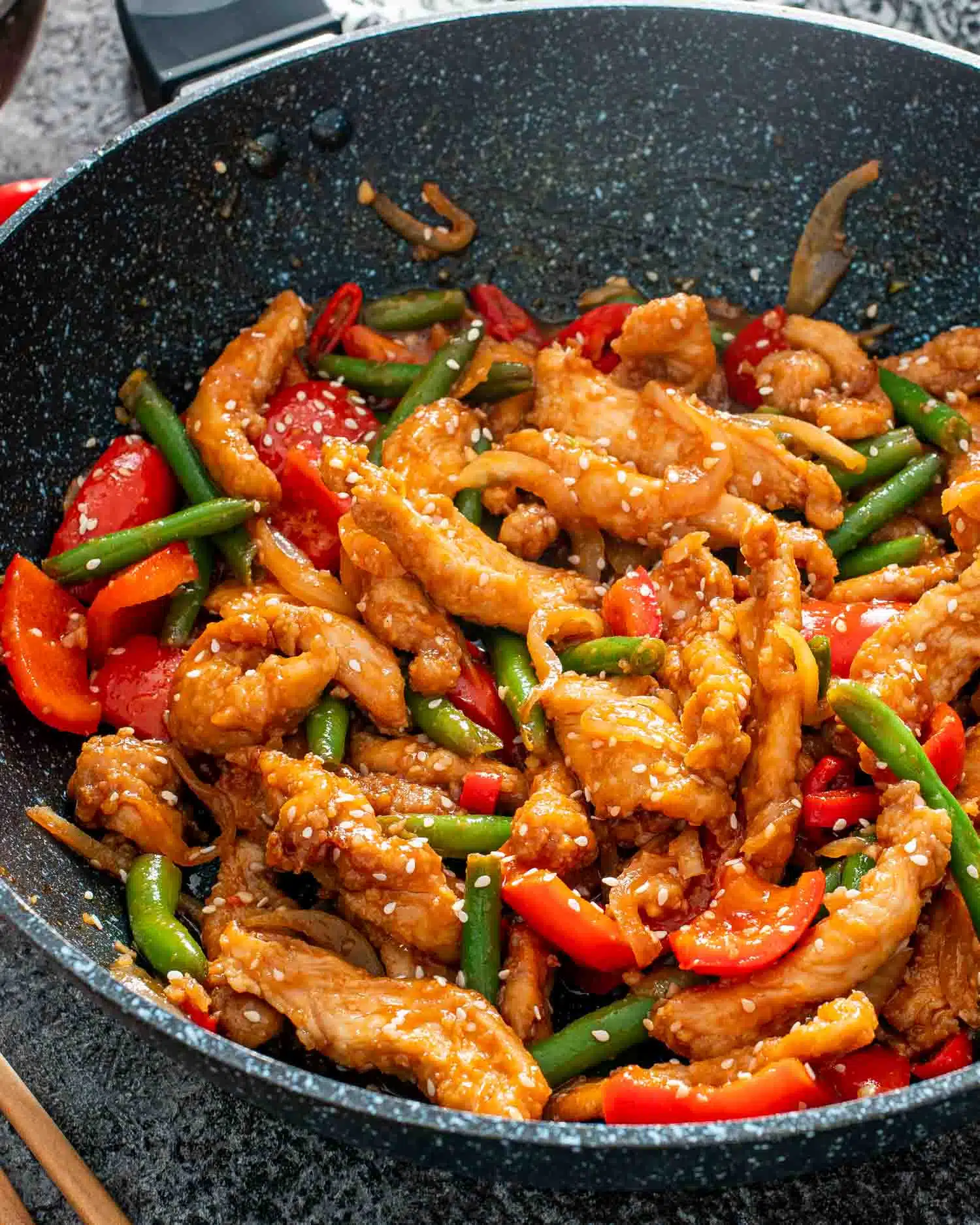 crispy honey chili chicken in a wok.