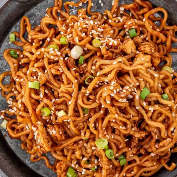 a serving of dragon noodles on a metal plate.