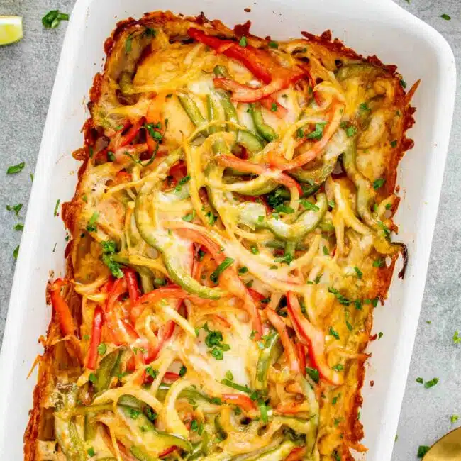 fajita chicken casserole in a white casserole dish fresh out of the oven.