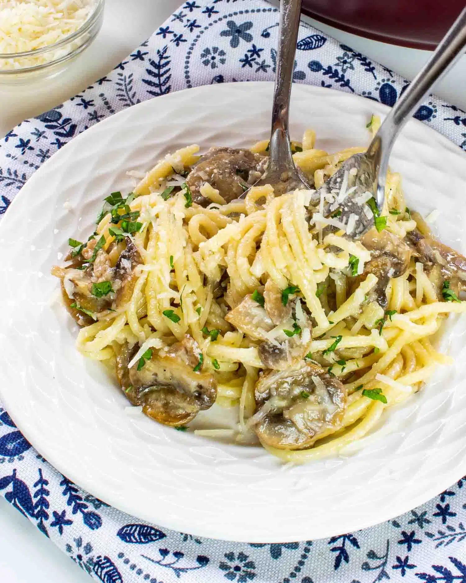 mushroom pasta in a plate with a fork in it.