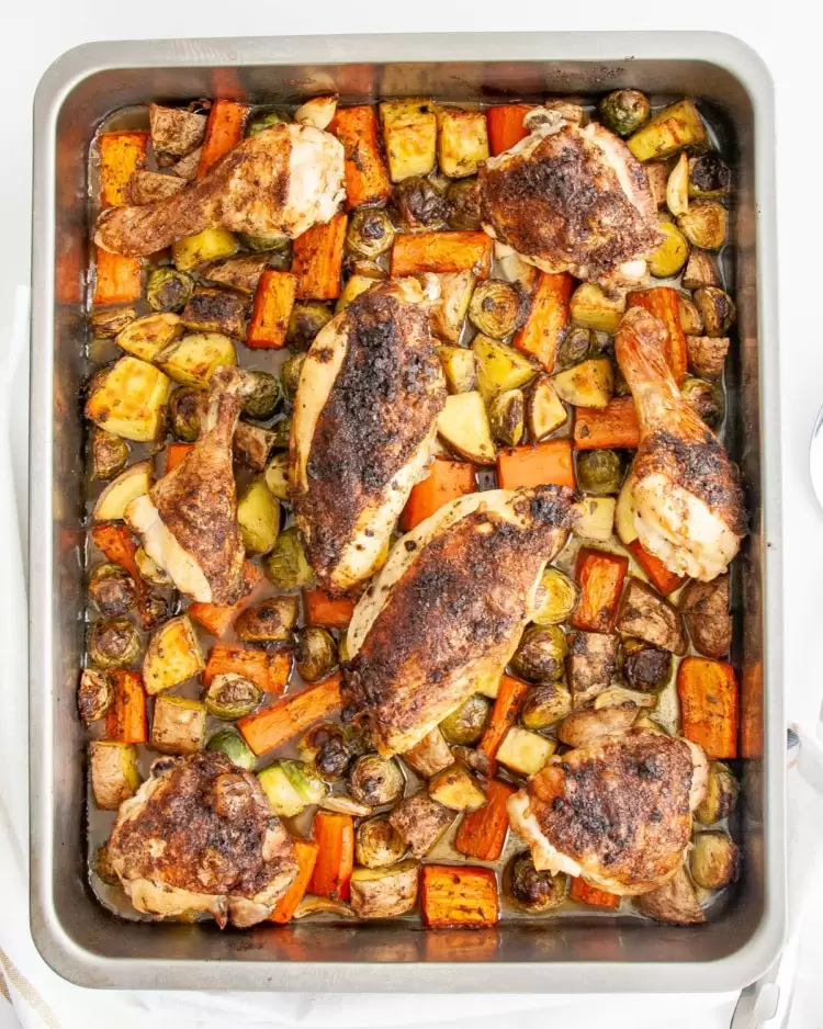overhead shot of roasted chicken and vegetables in a roasting pan
