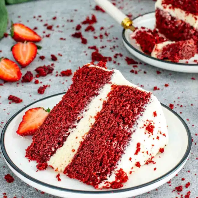a slice of red velvet cake on a white plate.